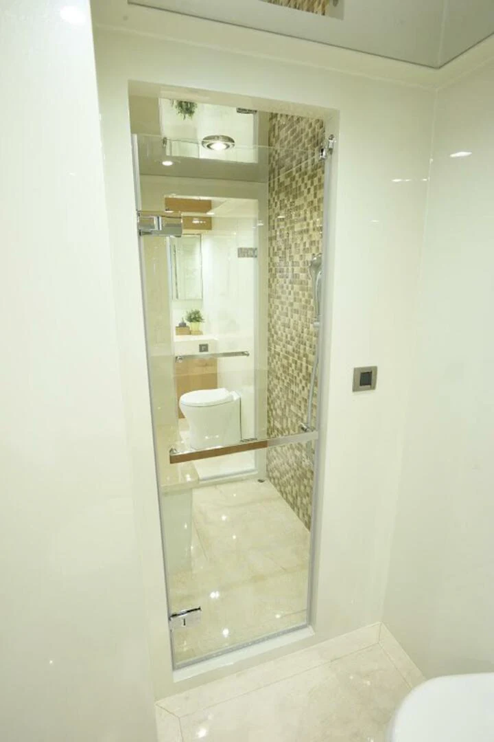 a bathroom with a glass shower aboard JOHNSON 93 OPEN FB Yacht for Sale