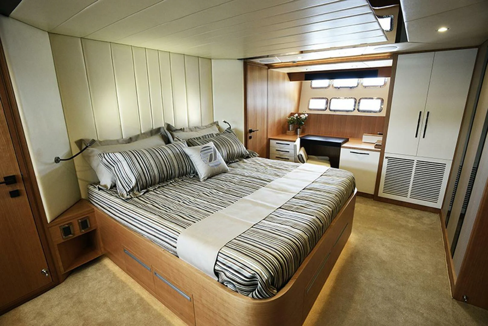 a bedroom with a bed and a desk aboard JOHNSON 93 OPEN FB Yacht for Sale