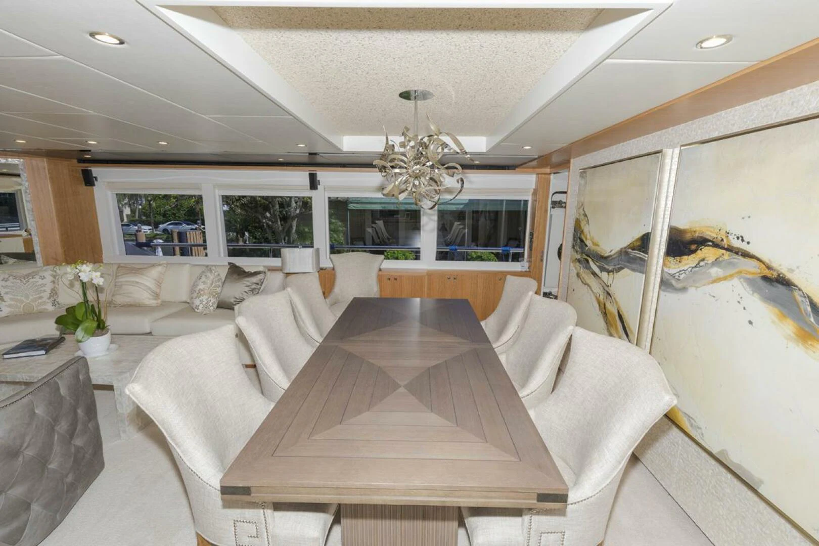 a large living room with white couches and a large chandelier aboard JOHNSON 93 OPEN FB Yacht for Sale