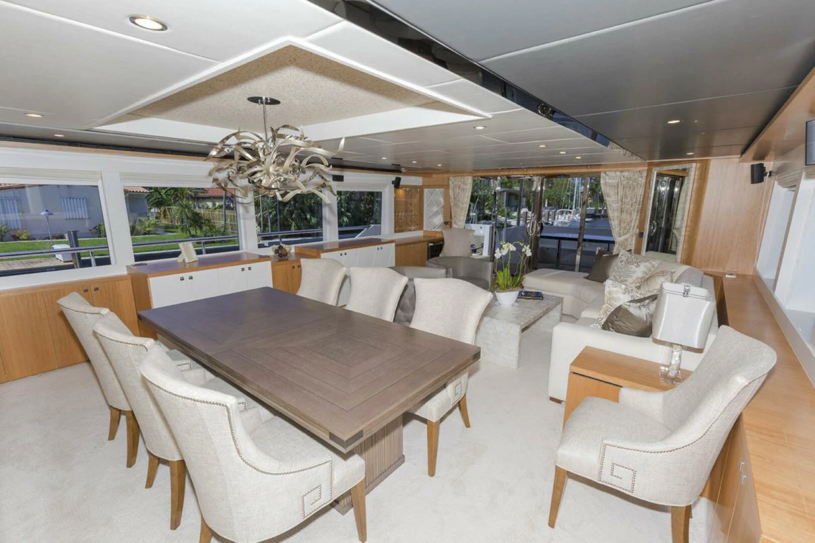 a room with a table chairs and a couch aboard JOHNSON 93 OPEN FB Yacht for Sale