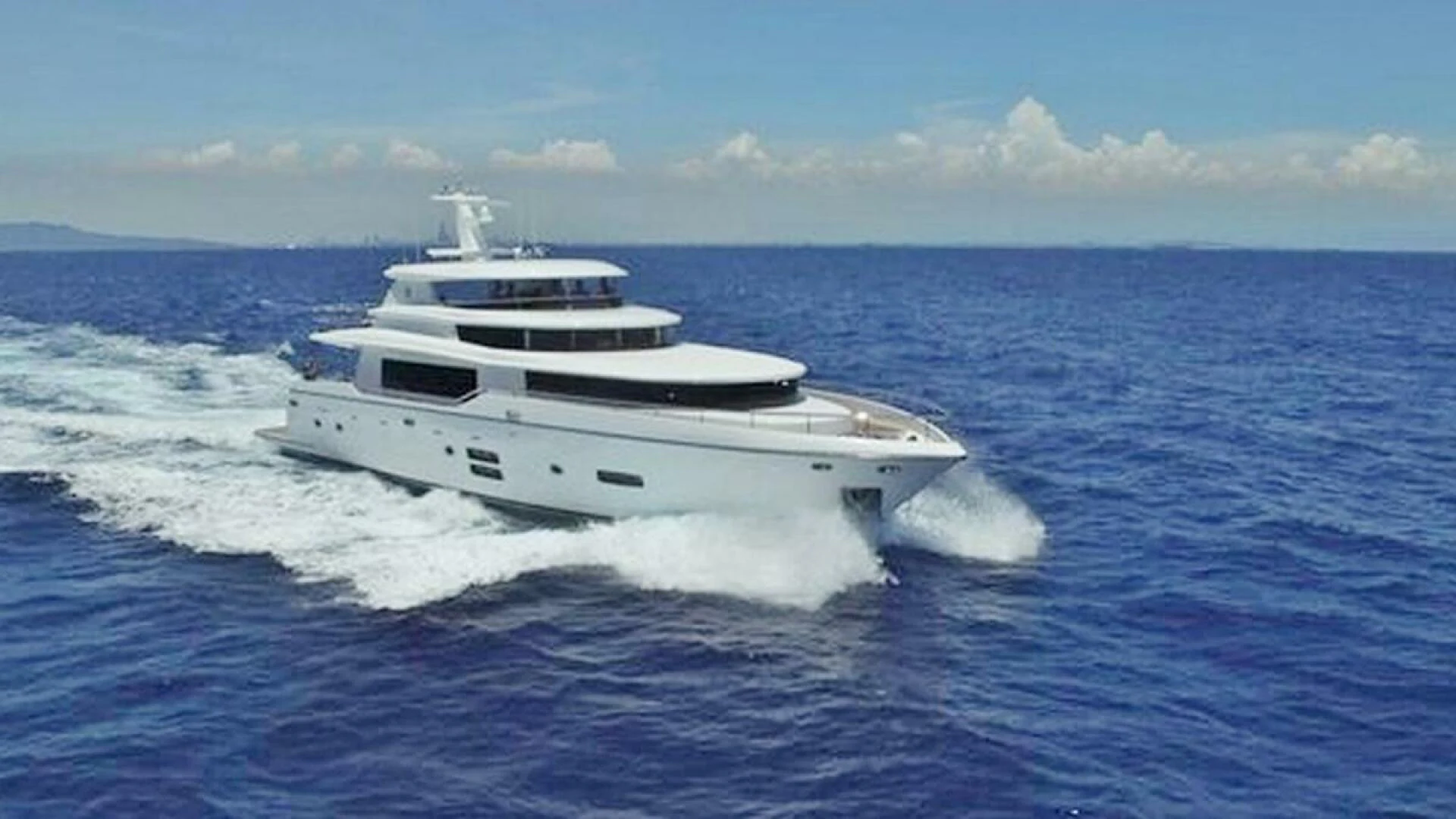 a white yacht on the water aboard JOHNSON 93 OPEN FB Yacht for Sale