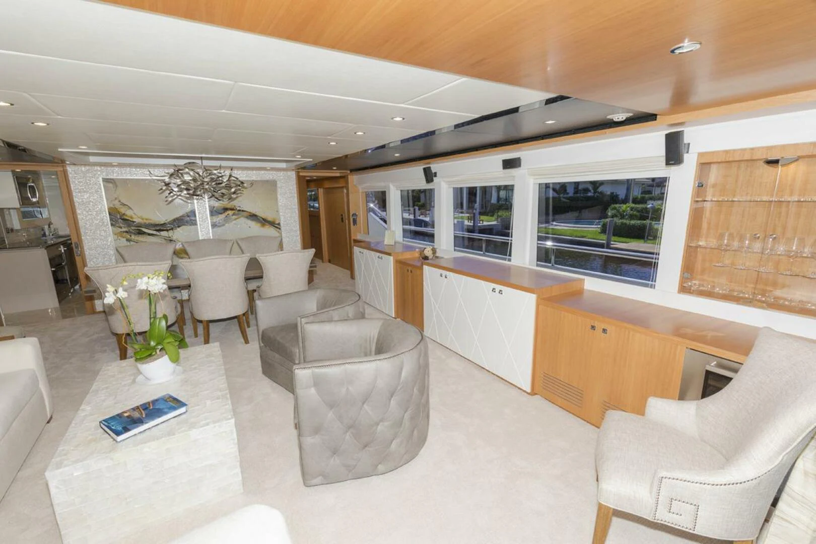 a room with a couch and chairs aboard JOHNSON 93 OPEN FB Yacht for Sale