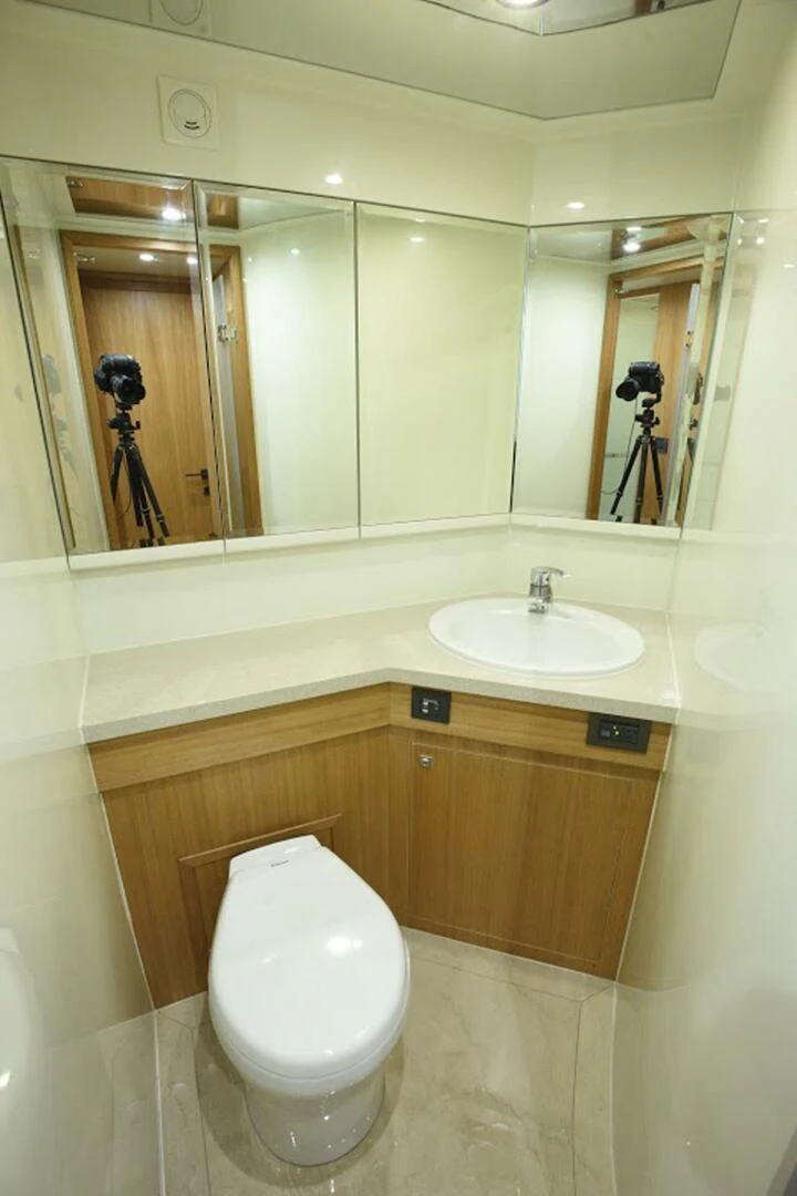 a bathroom with a toilet and a sink aboard JOHNSON 93 OPEN FB Yacht for Sale
