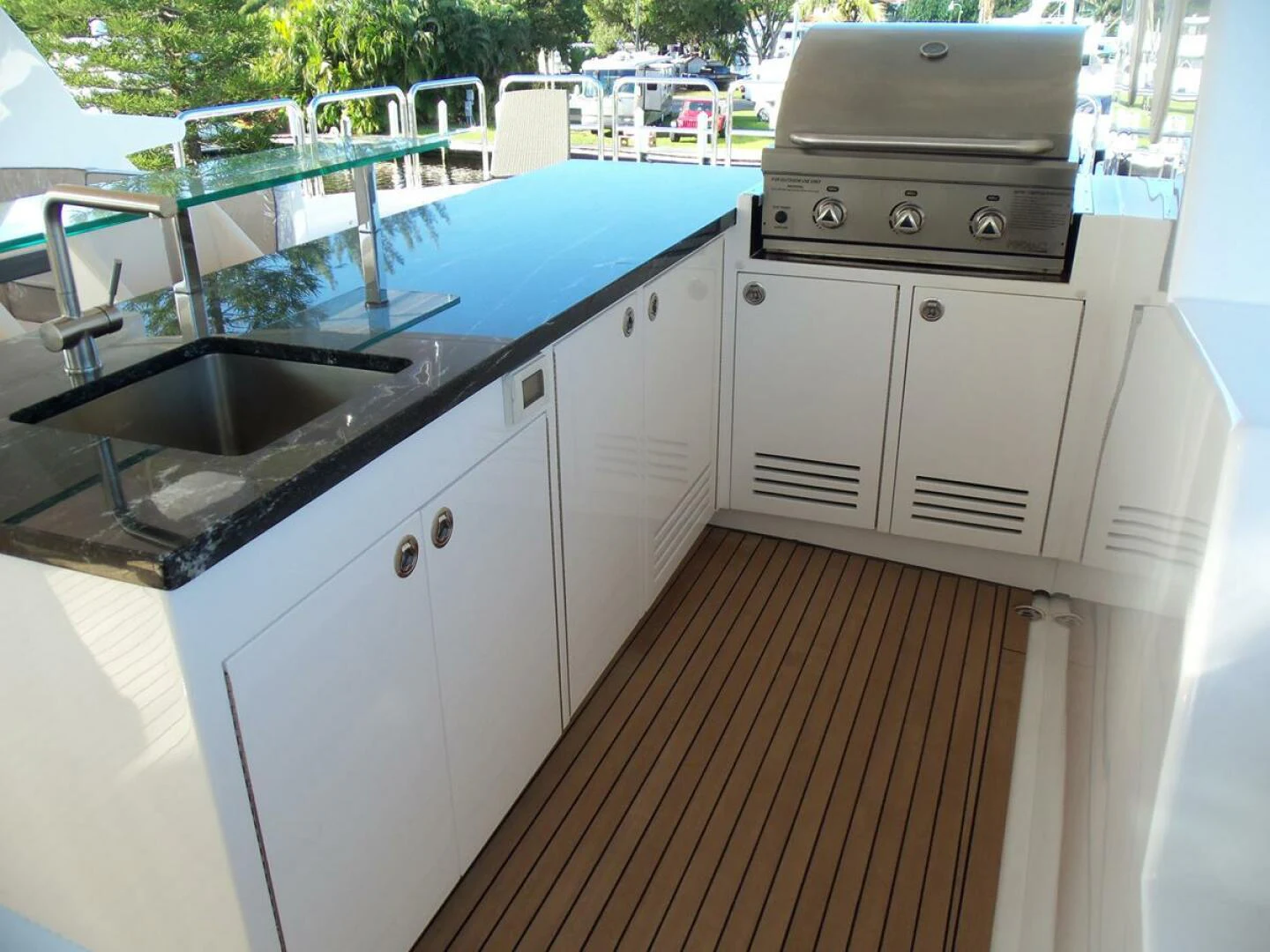 a kitchen with a stove and sink aboard JOHNSON 93 OPEN FB Yacht for Sale
