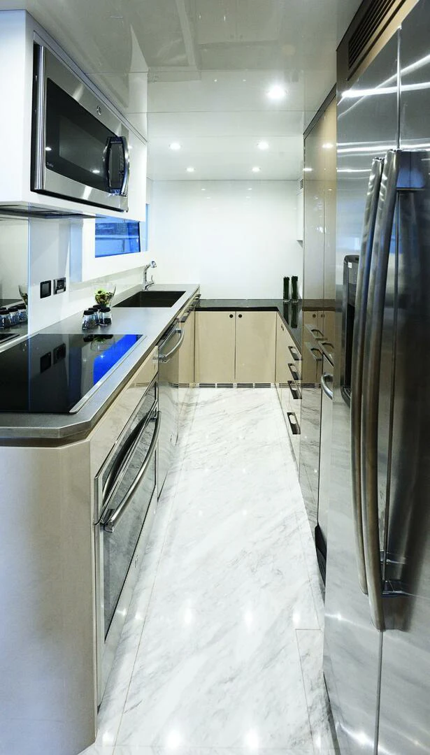 a kitchen with a stainless steel refrigerator aboard JOHNSON 93 OPEN FB Yacht for Sale