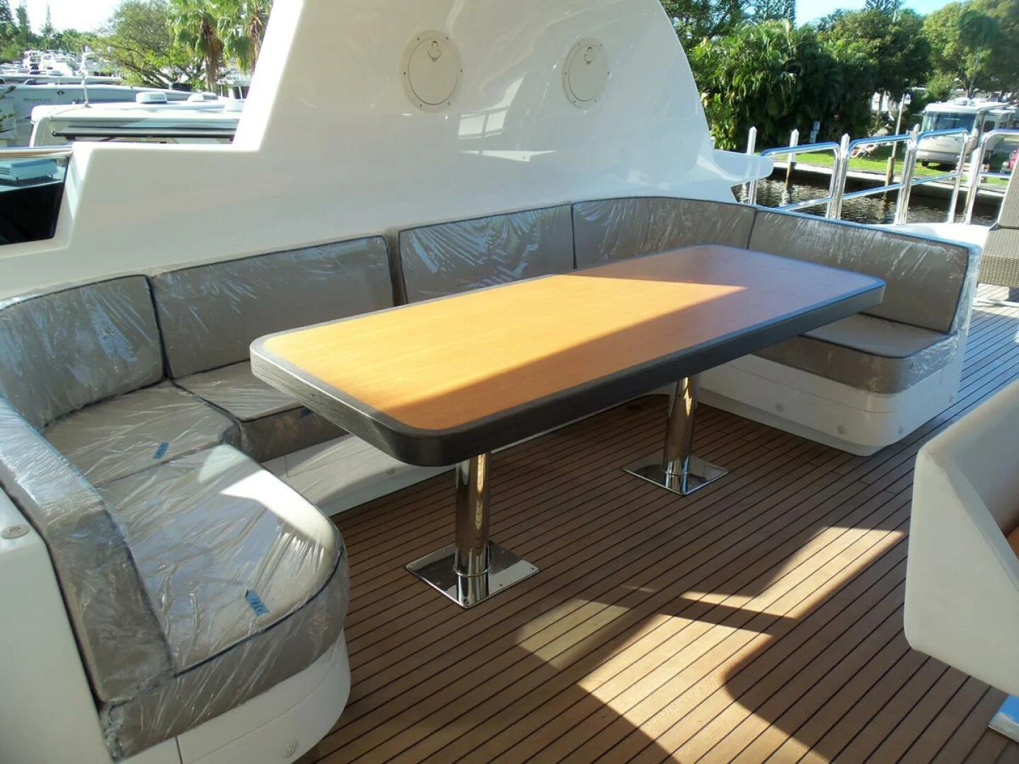 a table and chairs on a patio aboard JOHNSON 93 OPEN FB Yacht for Sale