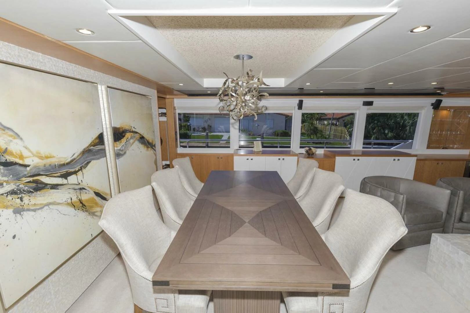 a living room with a large chandelier aboard JOHNSON 93 OPEN FB Yacht for Sale