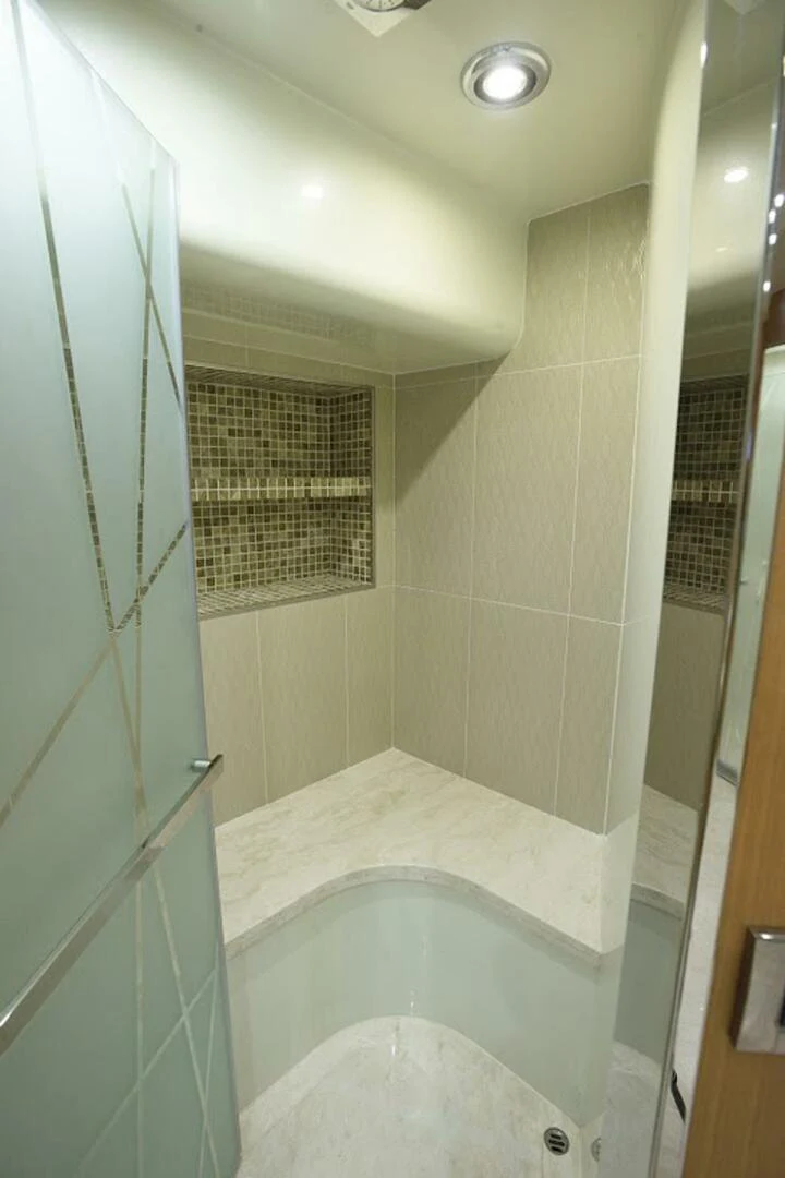 a bathroom with a tub and shower aboard JOHNSON 93 OPEN FB Yacht for Sale