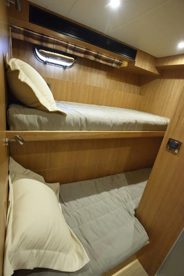a bed with white sheets aboard JOHNSON 93 OPEN FB Yacht for Sale