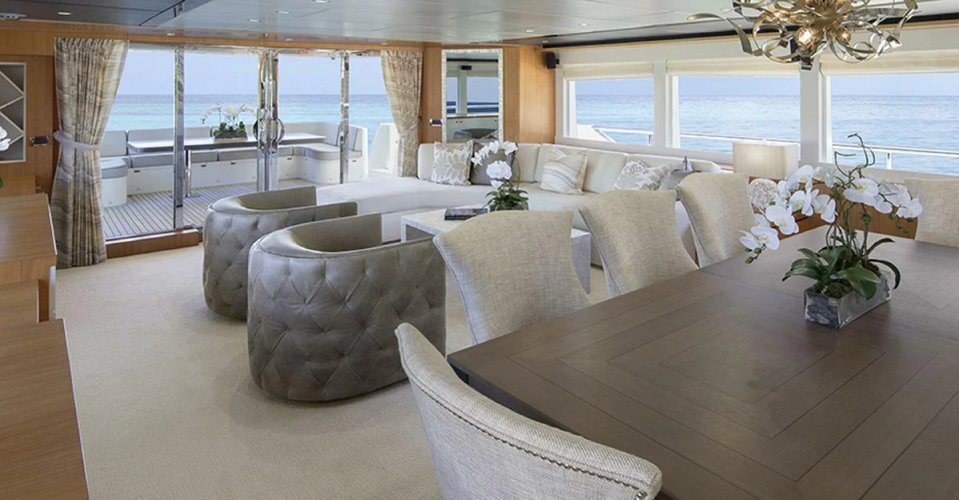 a large living room with a large table and chairs aboard JOHNSON 93 OPEN FB Yacht for Sale