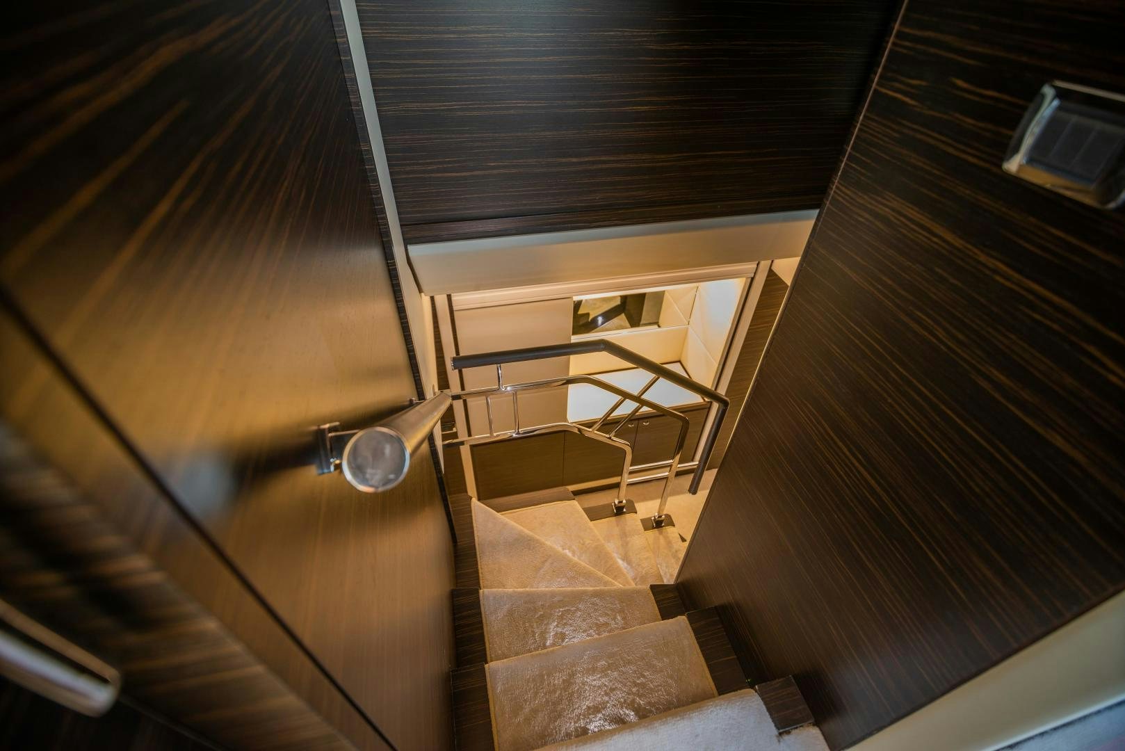 a wooden staircase with a light aboard ZAPHIRA Yacht for Sale