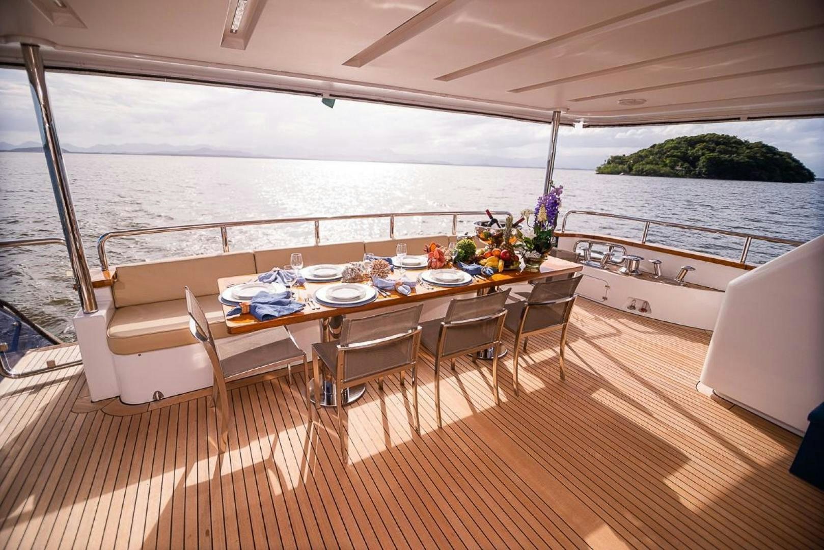 a table set for a meal on a deck aboard ZAPHIRA Yacht for Sale