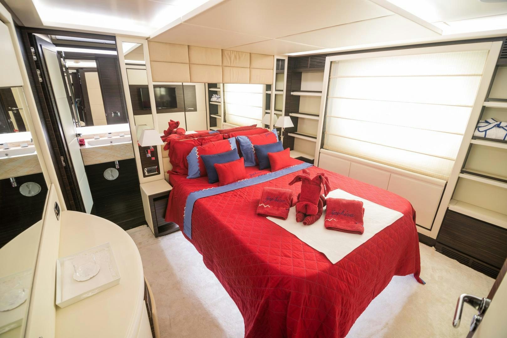 a bedroom with a red bed aboard ZAPHIRA Yacht for Sale