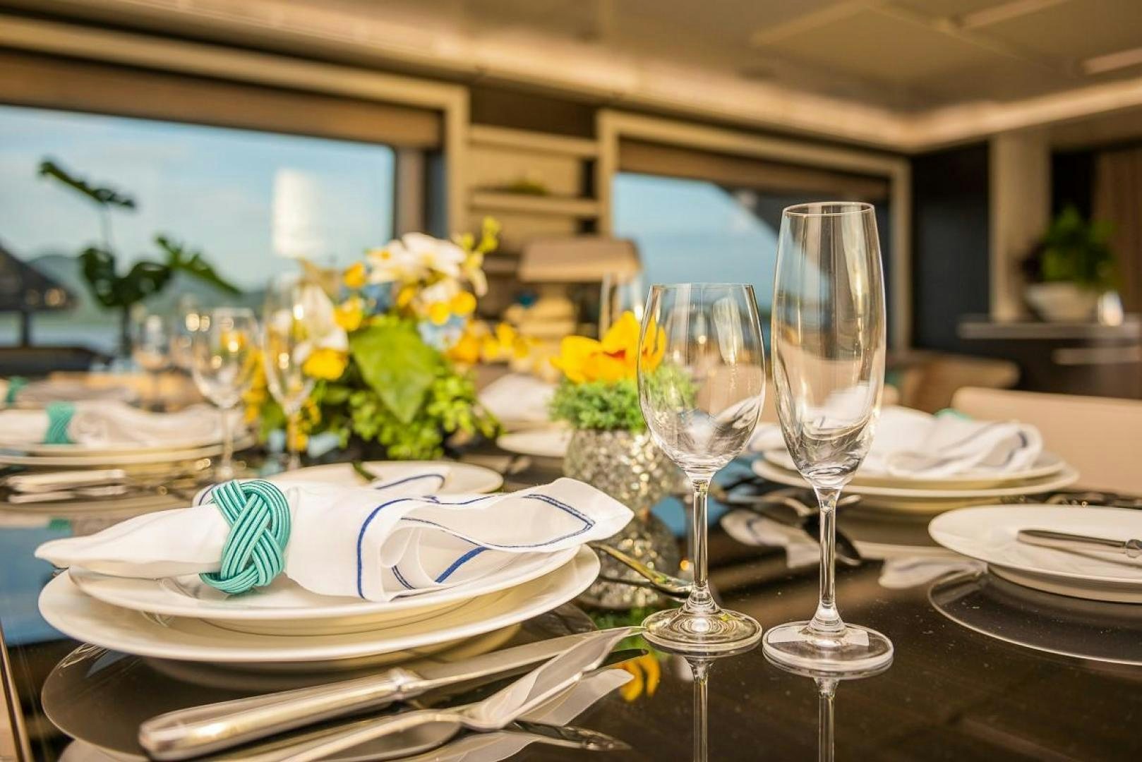 a table with plates and glasses aboard ZAPHIRA Yacht for Sale
