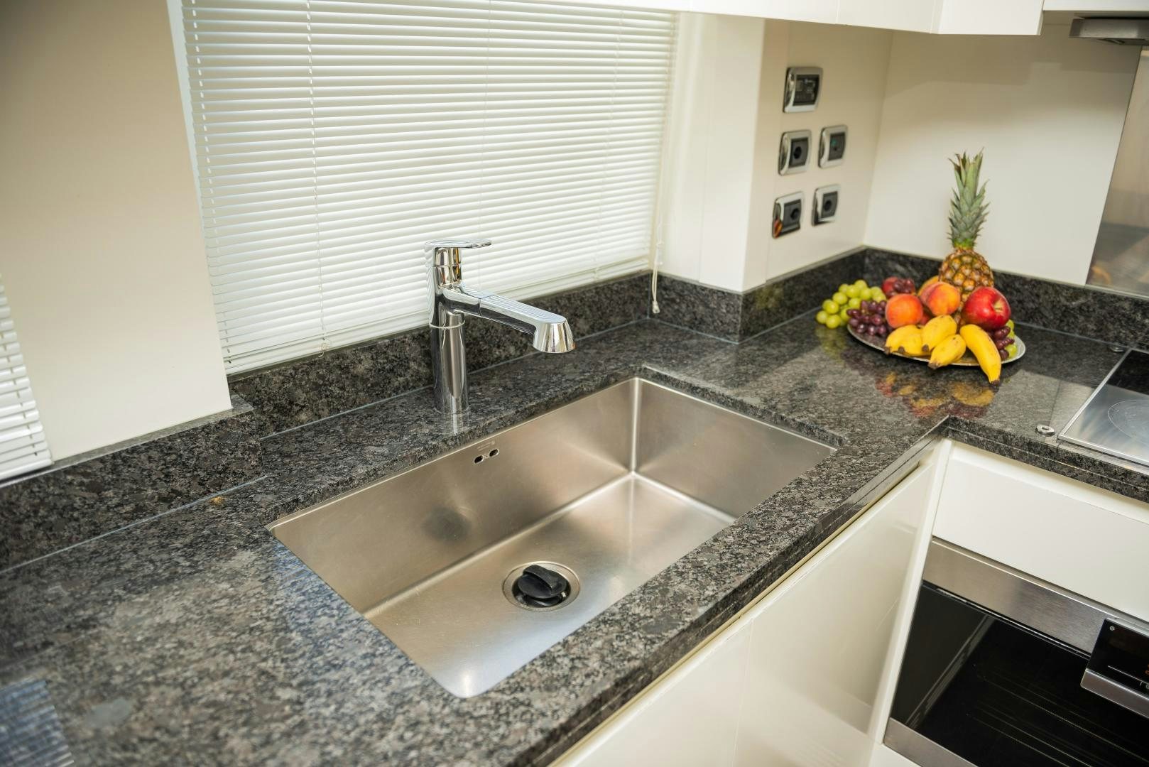 a kitchen with a marble counter top aboard ZAPHIRA Yacht for Sale