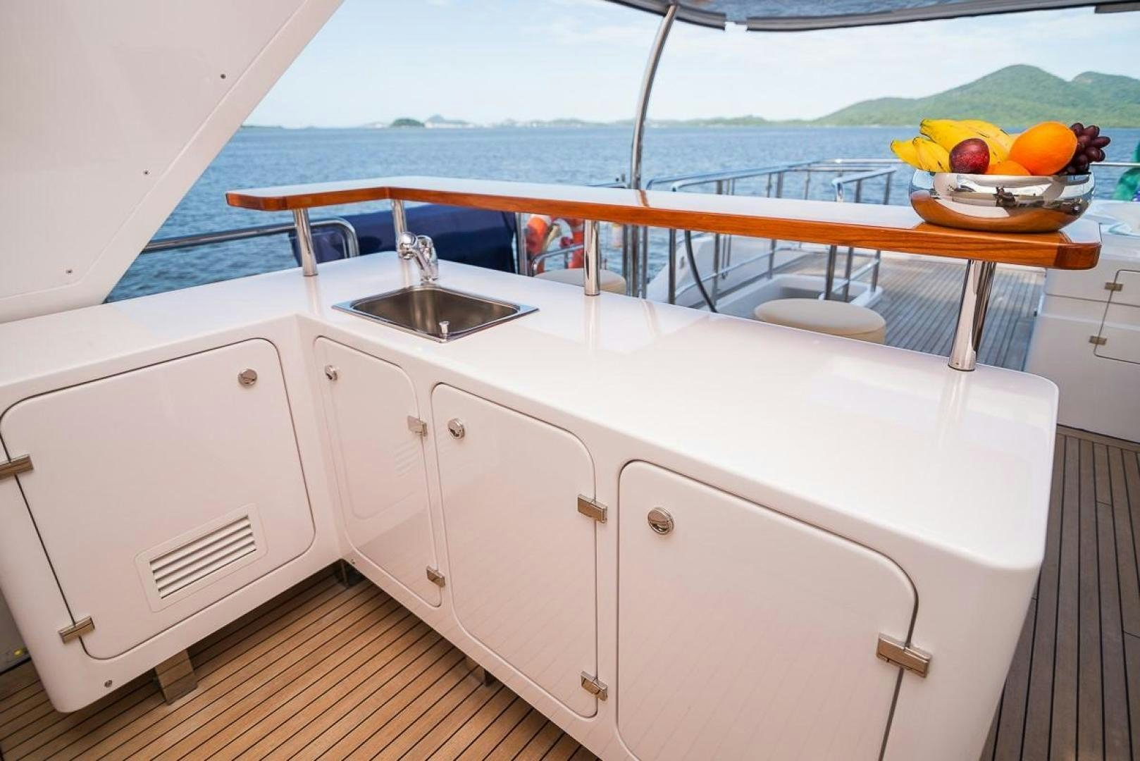 a boat with white cabinets and a sink on a deck aboard ZAPHIRA Yacht for Sale