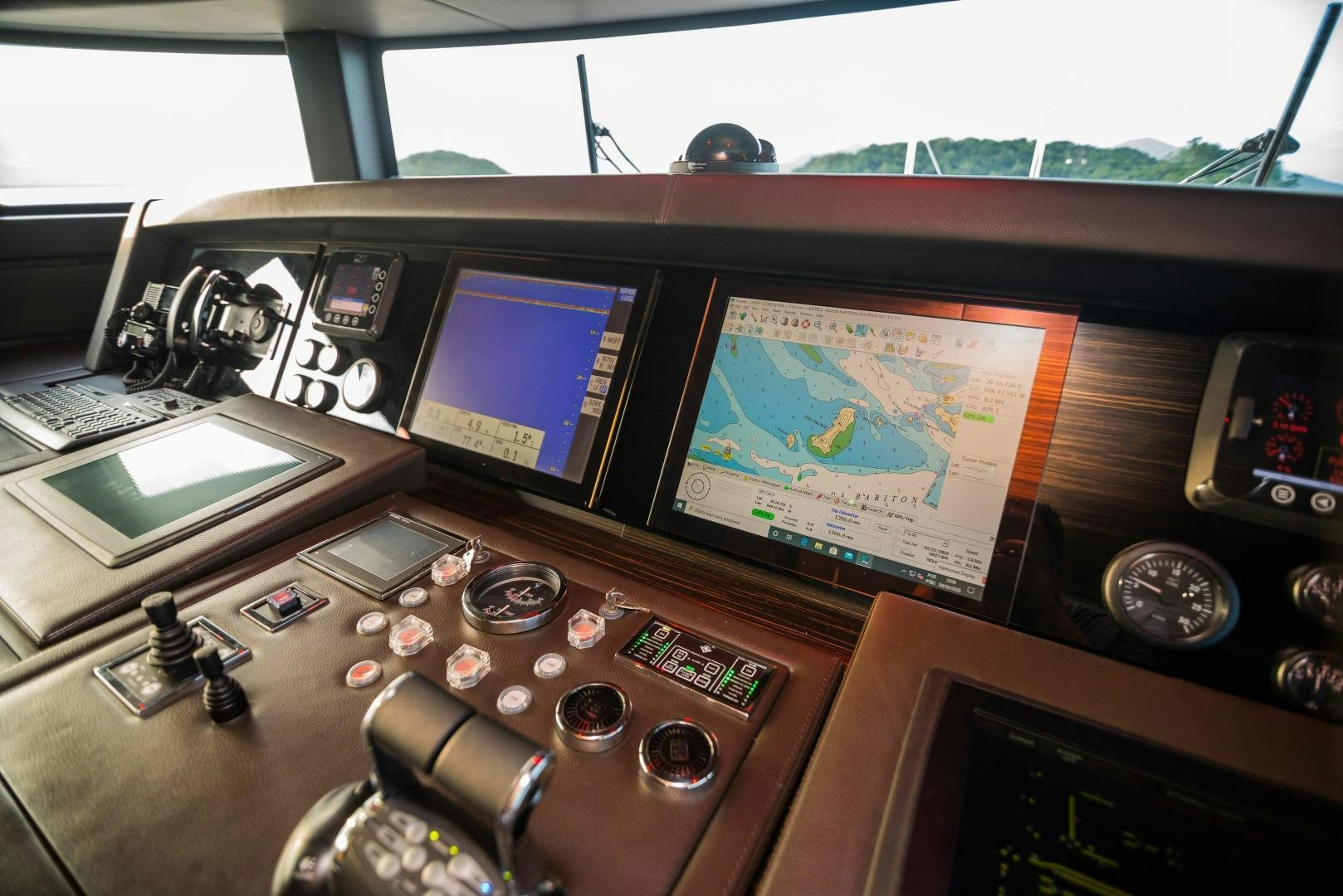 a desk with a laptop and electronic equipment on it aboard ZAPHIRA Yacht for Sale