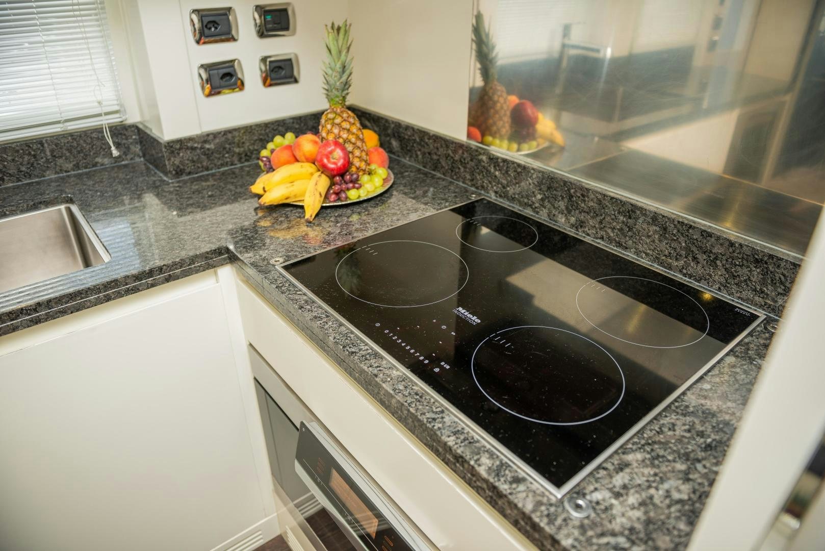 a kitchen with a black stove and a black pan on a counter aboard ZAPHIRA Yacht for Sale