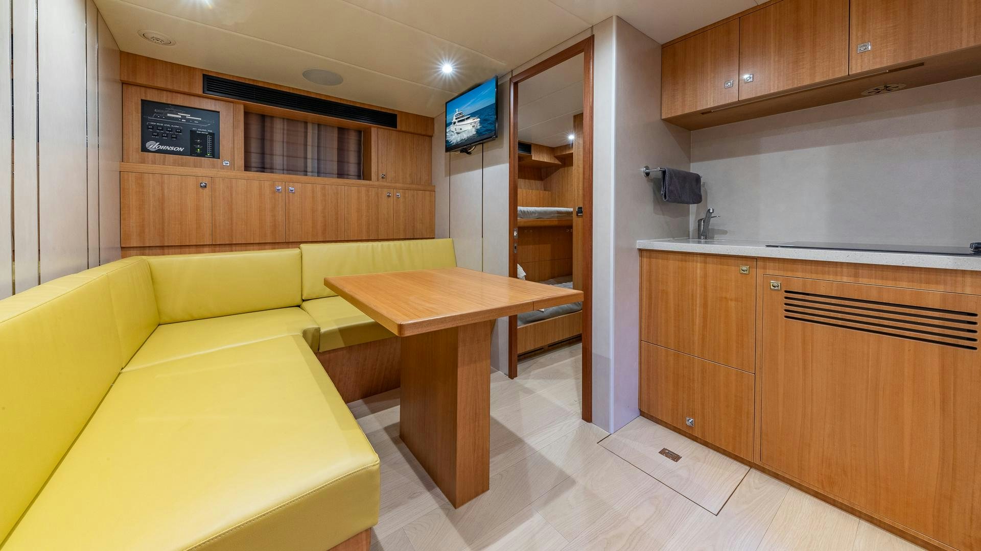 a living room with a yellow couch aboard LIFE FOR SALE Yacht for Sale