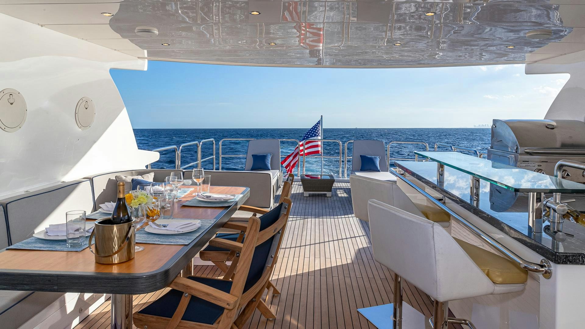 a room with a table and chairs and a boat on the water aboard LIFE FOR SALE Yacht for Sale