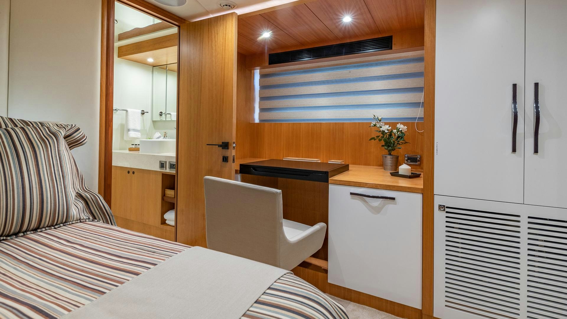 a room with a bed and desk aboard LIFE FOR SALE Yacht for Sale