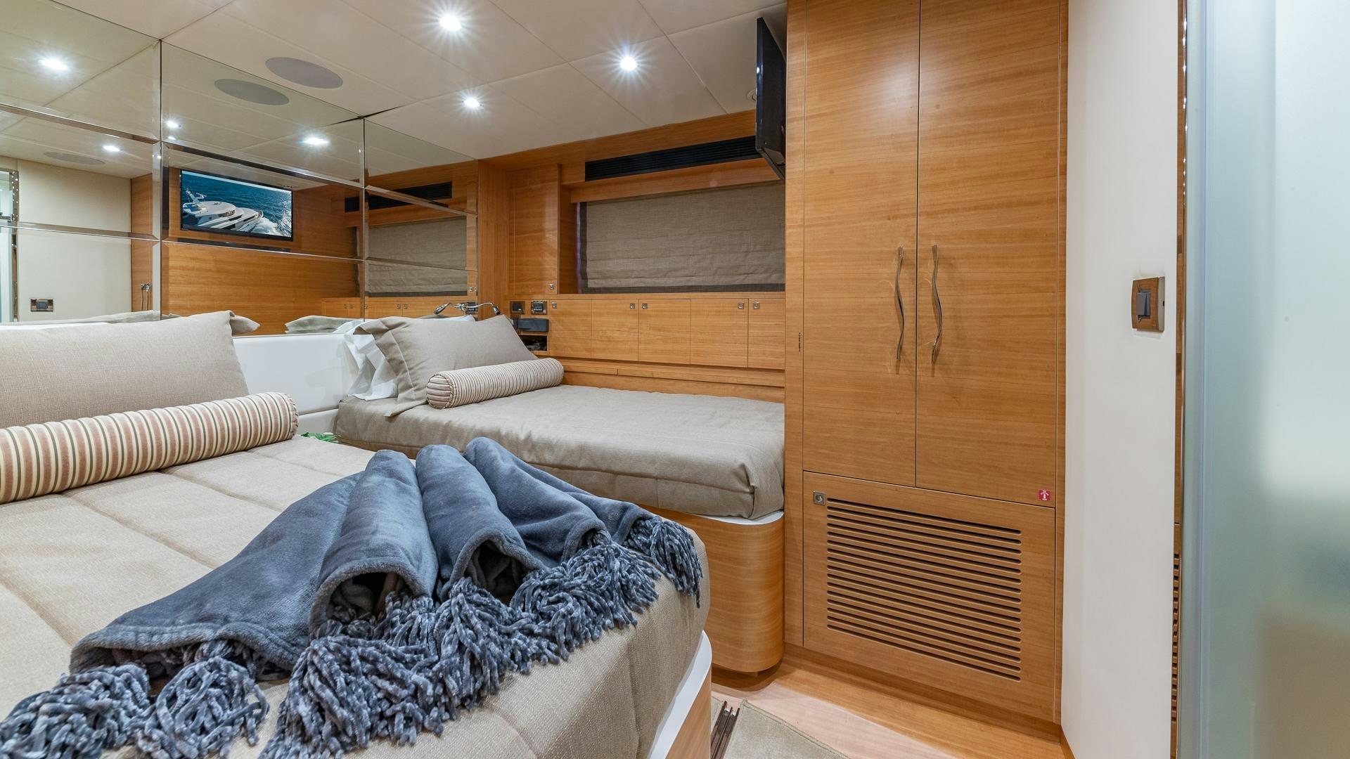 a room with a bed and a wood cabinet aboard LIFE FOR SALE Yacht for Sale