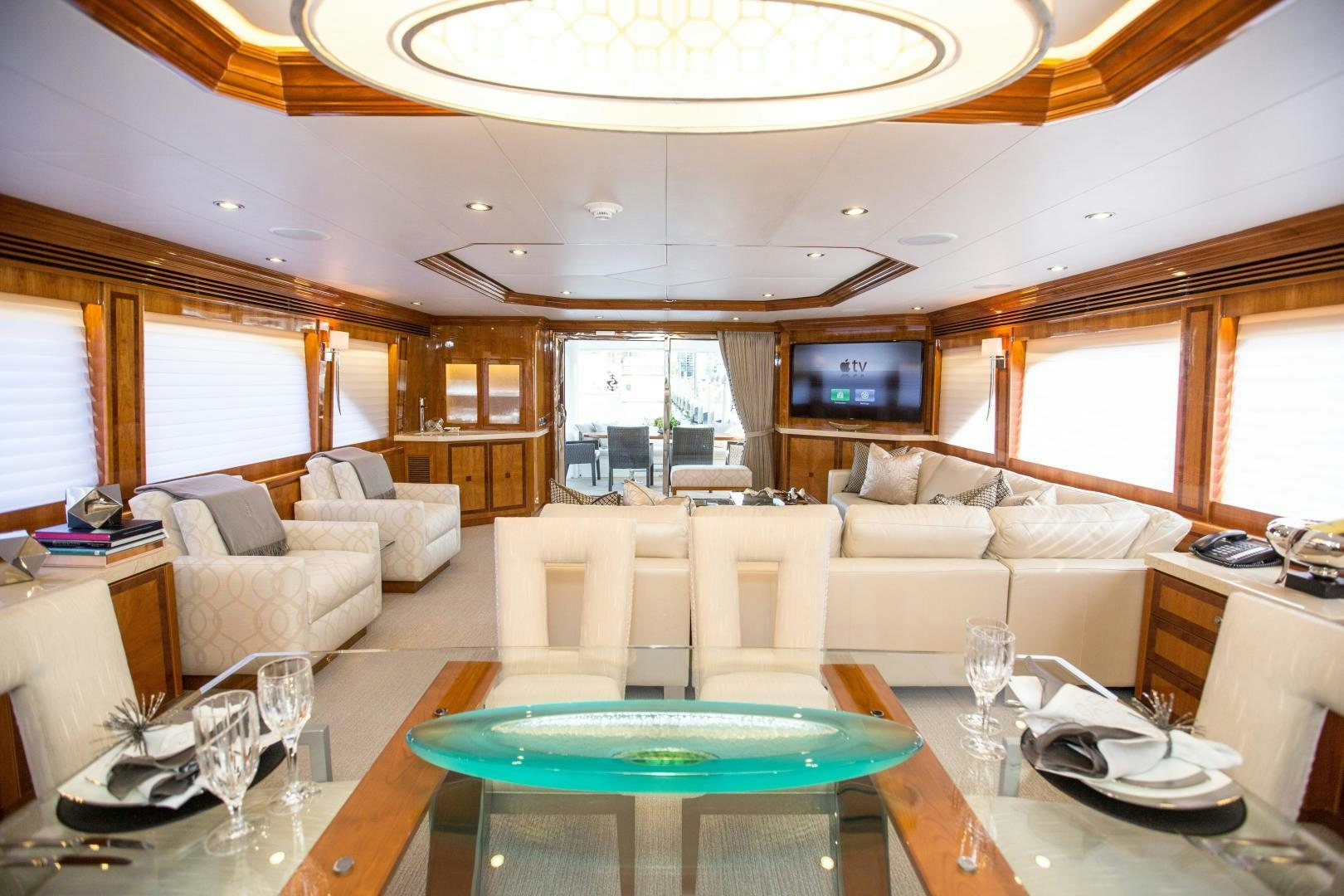 a living room with a table and chairs aboard STERLING V Yacht for Sale