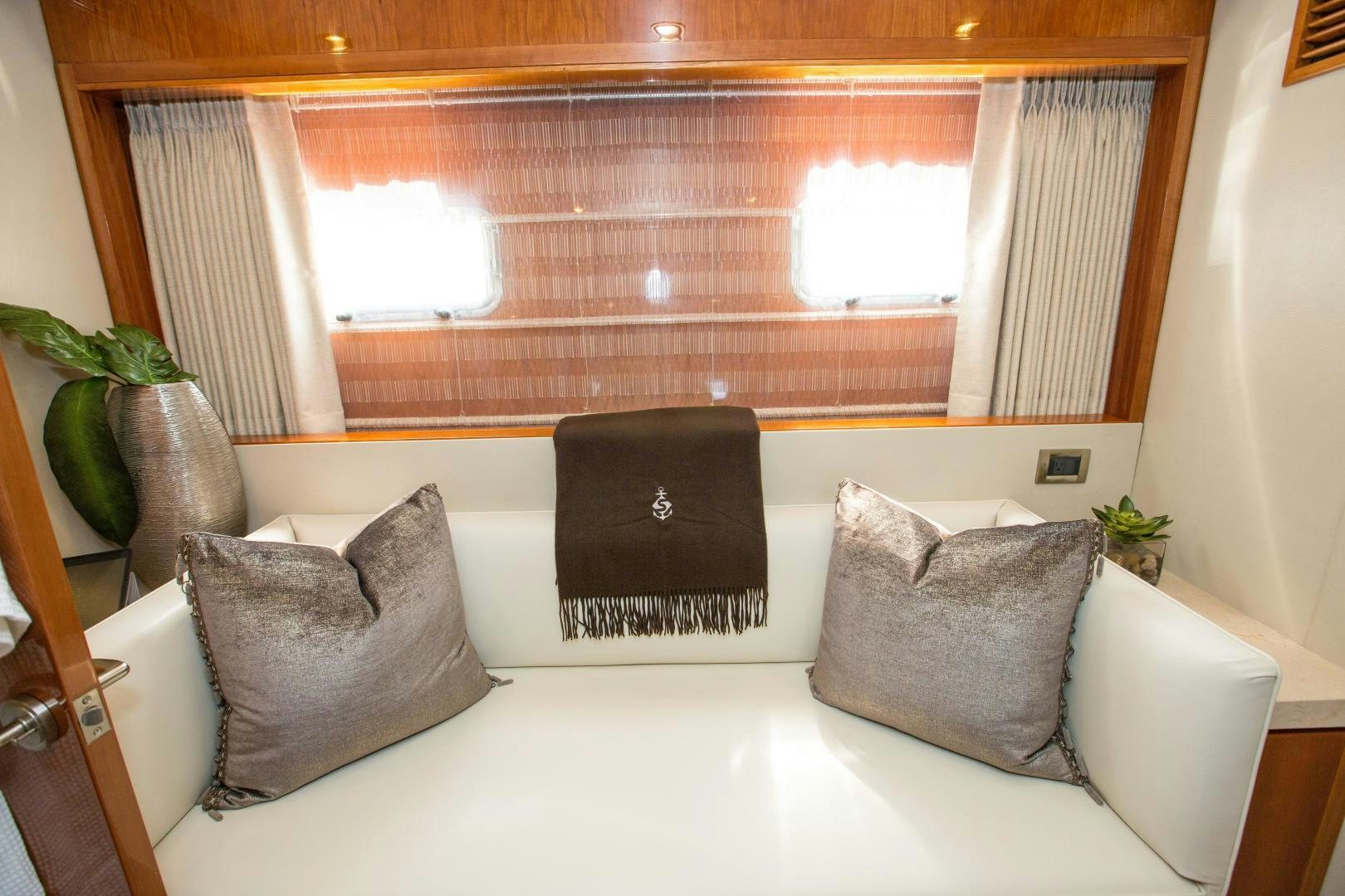 a couch and a laptop in a room aboard STERLING V Yacht for Sale
