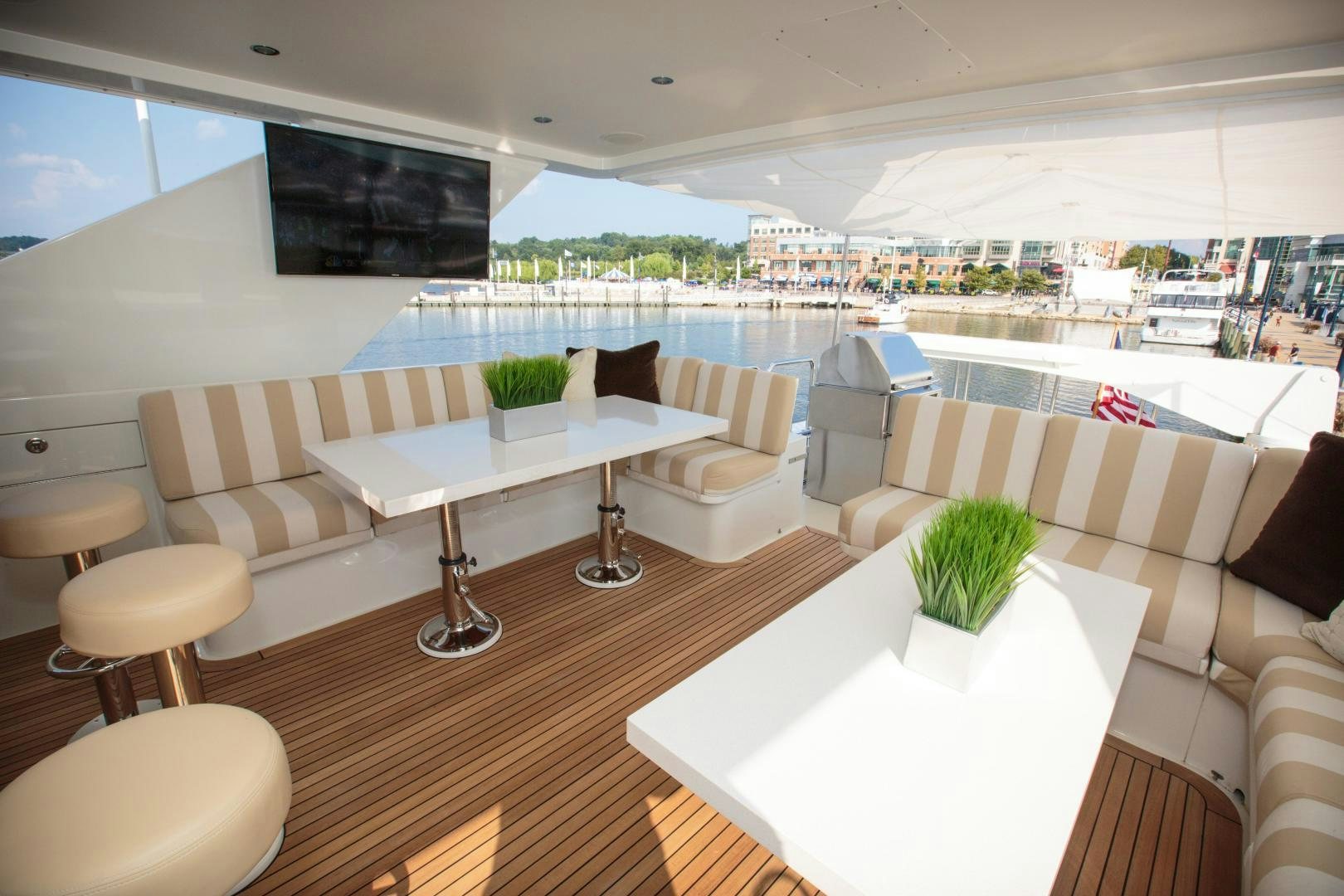 a room with a table chairs and plants aboard STERLING V Yacht for Sale
