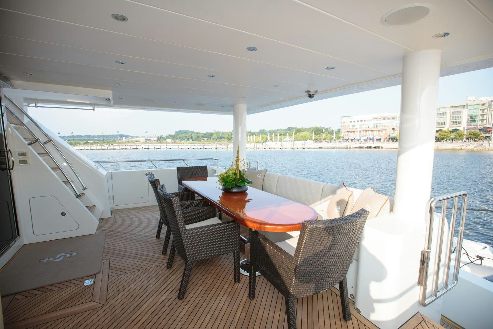 a table and chairs on a deck aboard STERLING V Yacht for Sale