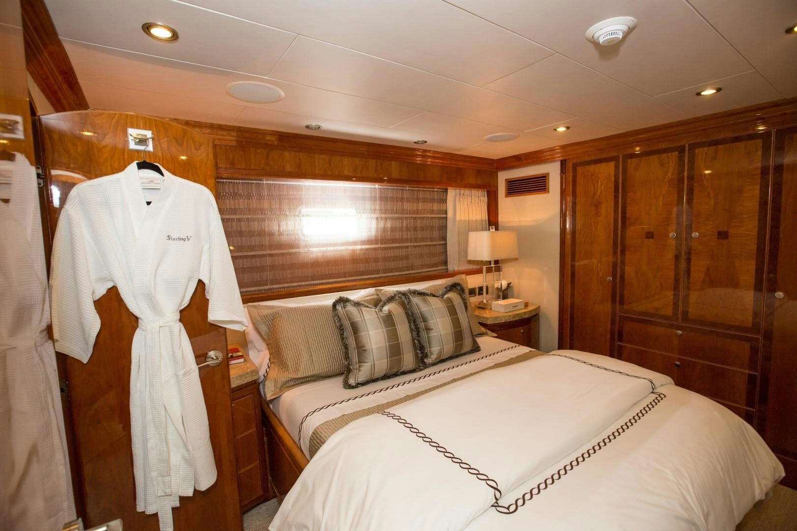 a room with a bed and a robe from the ceiling aboard STERLING V Yacht for Sale