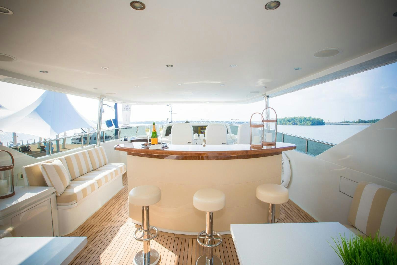 a room with a table chairs and a view of the ocean aboard STERLING V Yacht for Sale
