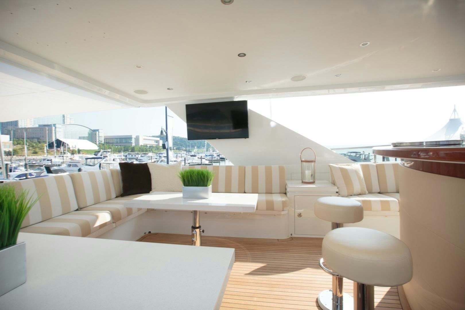 a room with white couches and a television aboard STERLING V Yacht for Sale