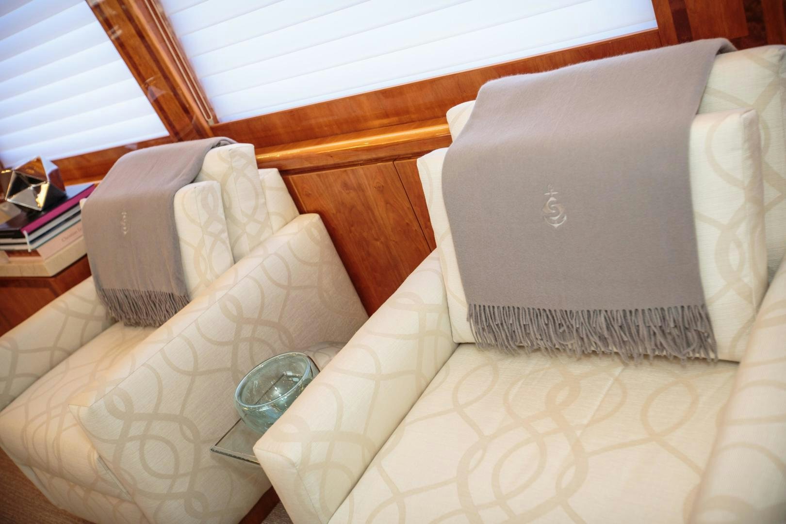 a bed with a pillow and a glass of water on it aboard STERLING V Yacht for Sale