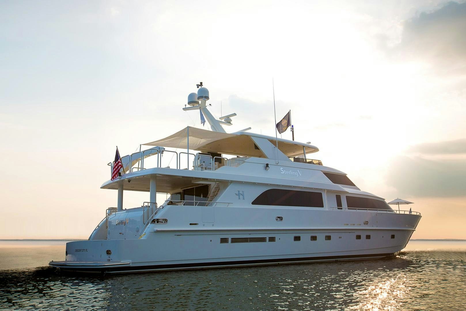 a white yacht on the water aboard STERLING V Yacht for Sale