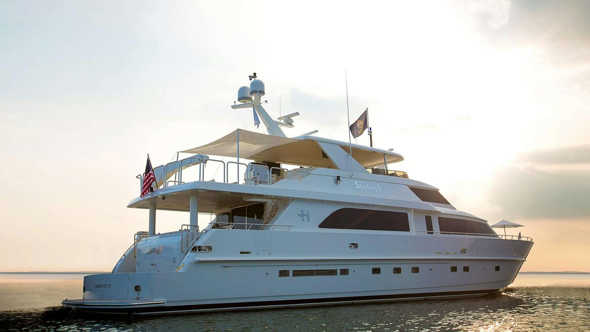 a white yacht on the water aboard STERLING V Yacht for Sale