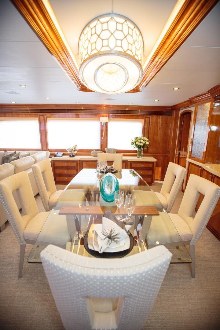a dining room with a chandelier aboard STERLING V Yacht for Sale
