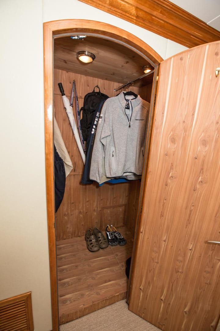 a closet with clothes on the wall aboard STERLING V Yacht for Sale
