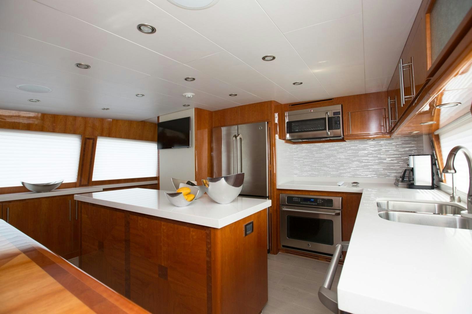 a kitchen with wooden cabinets aboard STERLING V Yacht for Sale