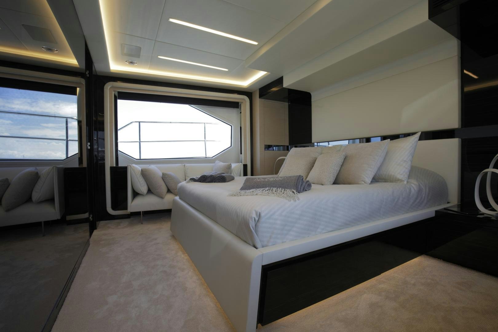 a room with a bed and a window aboard NOVASTAR Yacht for Sale