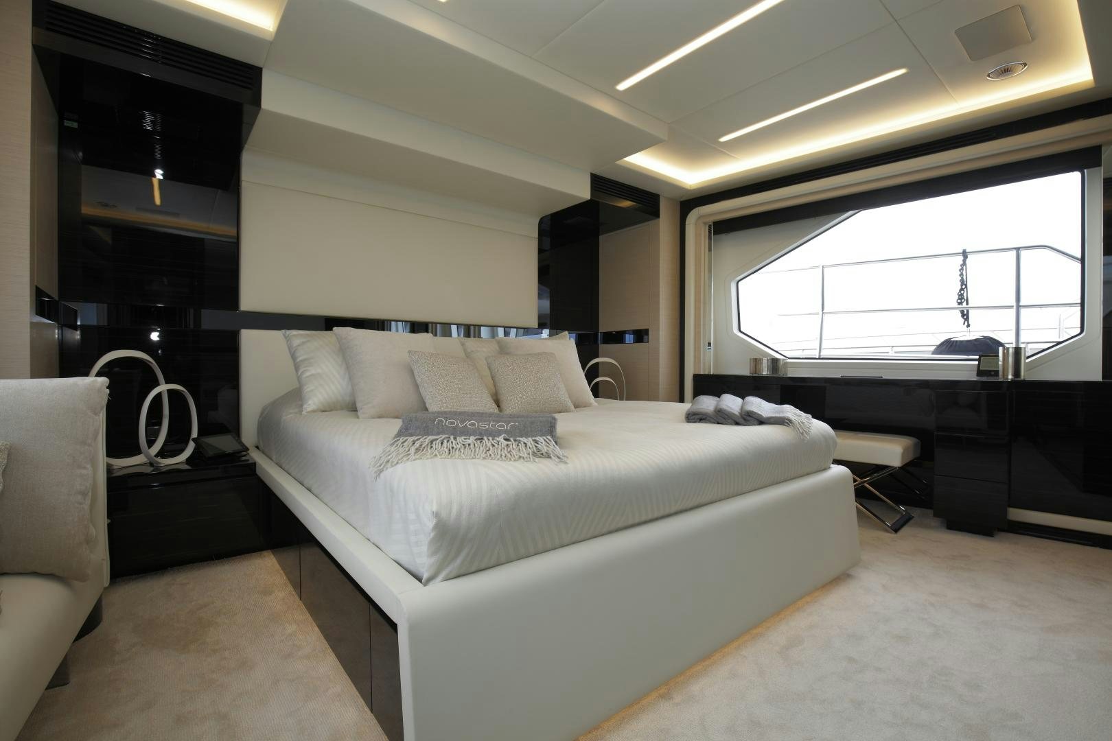 a room with a bed and a window aboard NOVASTAR Yacht for Sale