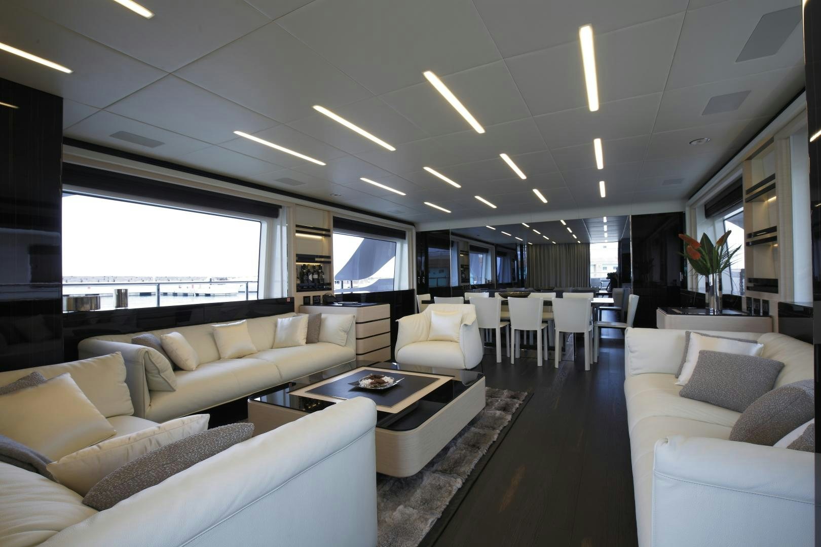 a large living room with white couches and a large window aboard NOVASTAR Yacht for Sale
