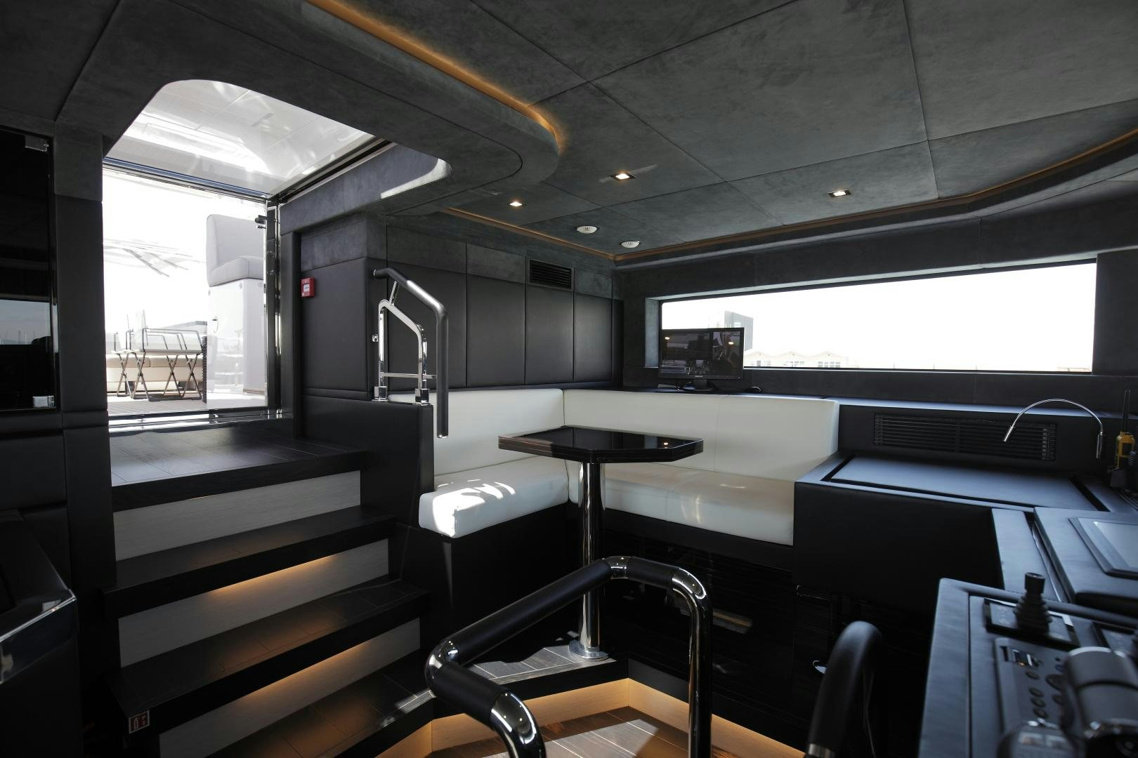 a room with desks and chairs aboard NOVASTAR Yacht for Sale