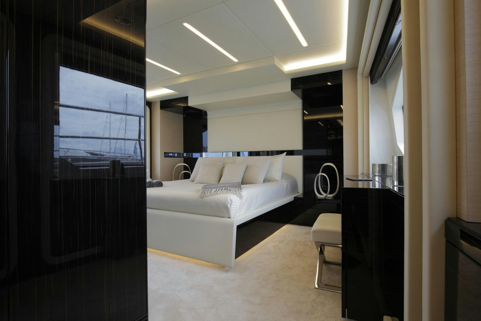 a bedroom with a bed and a window aboard NOVASTAR Yacht for Sale