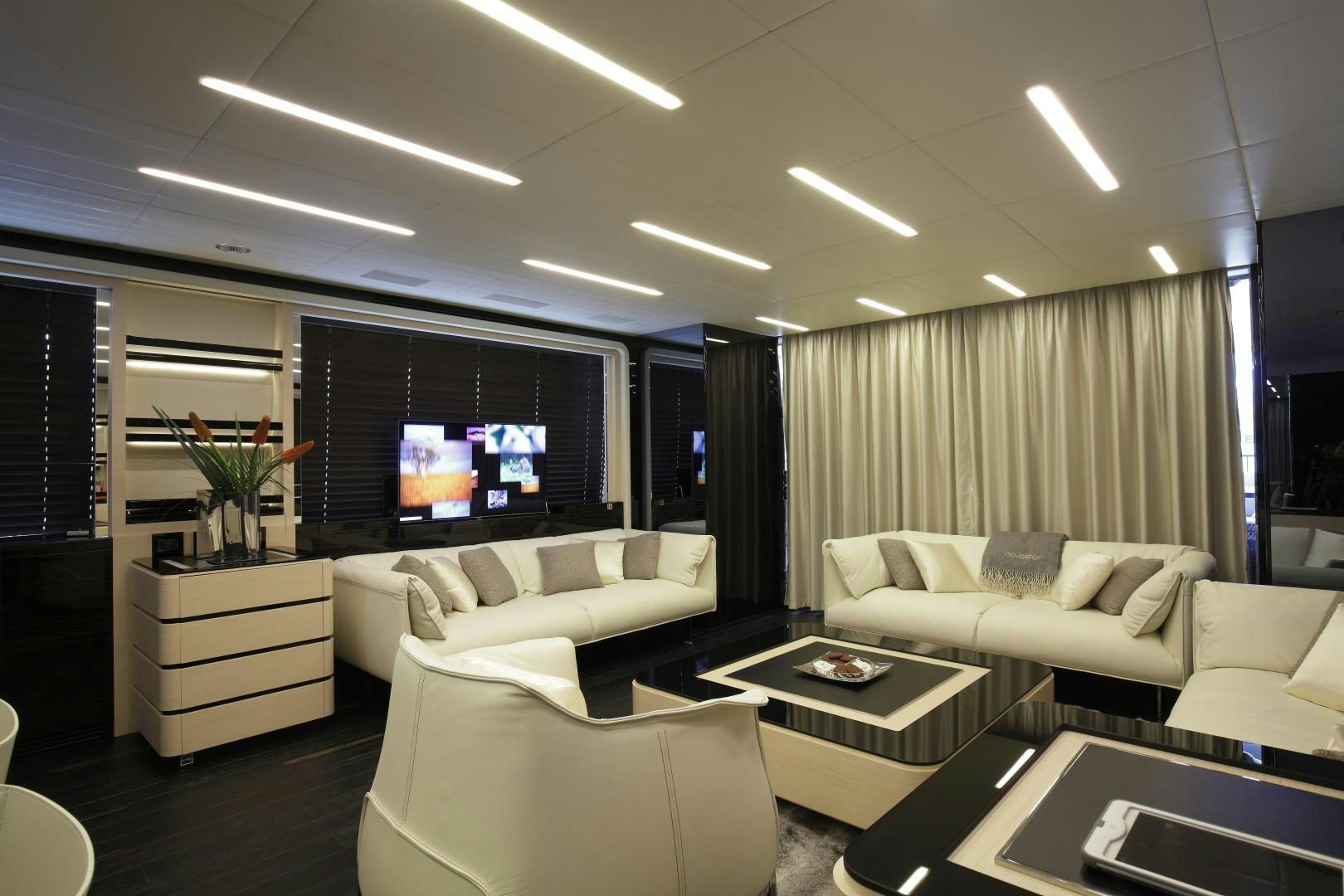 a room with a couch and a tv aboard NOVASTAR Yacht for Sale