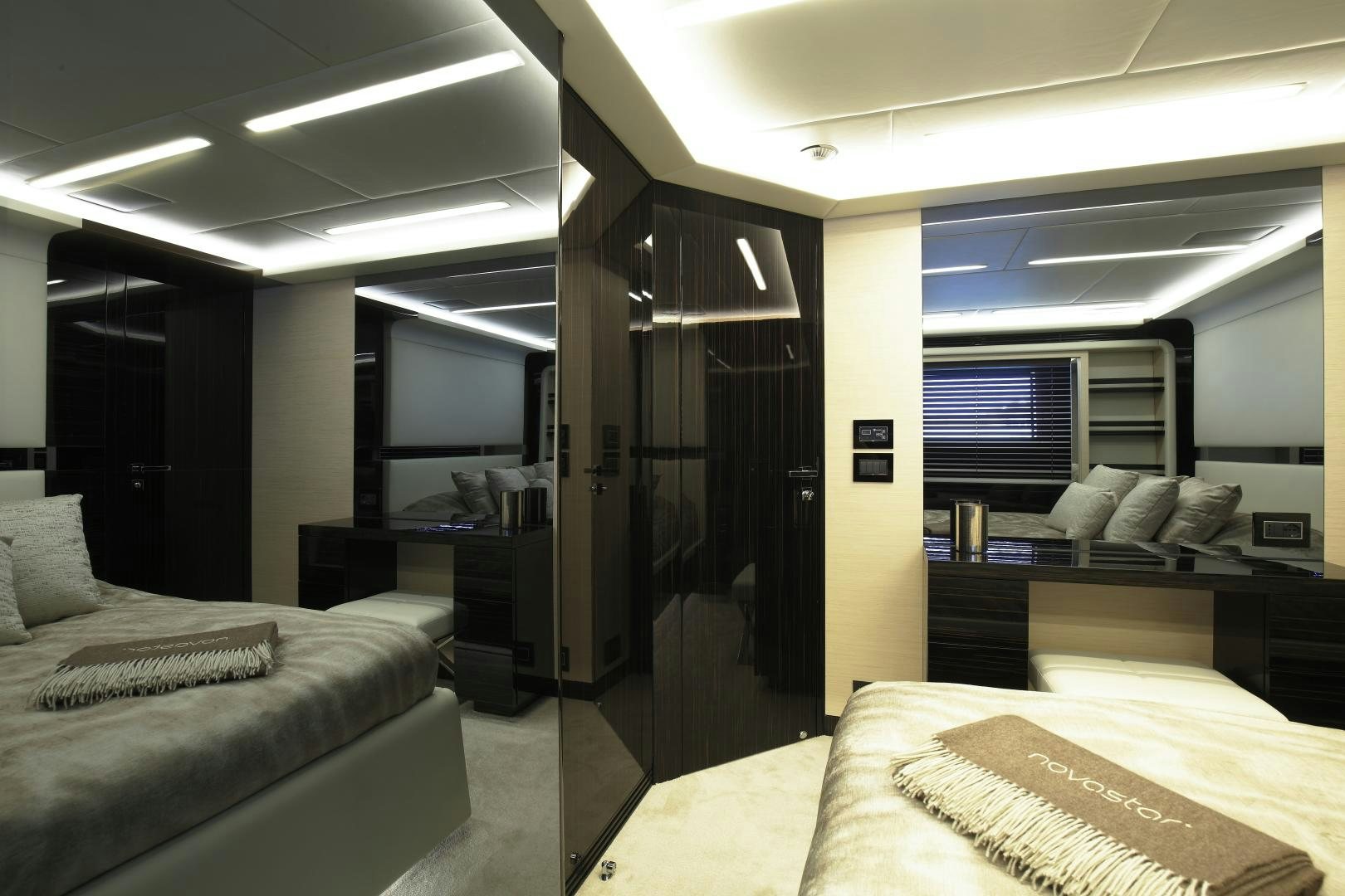 a room with a bed and a desk aboard NOVASTAR Yacht for Sale