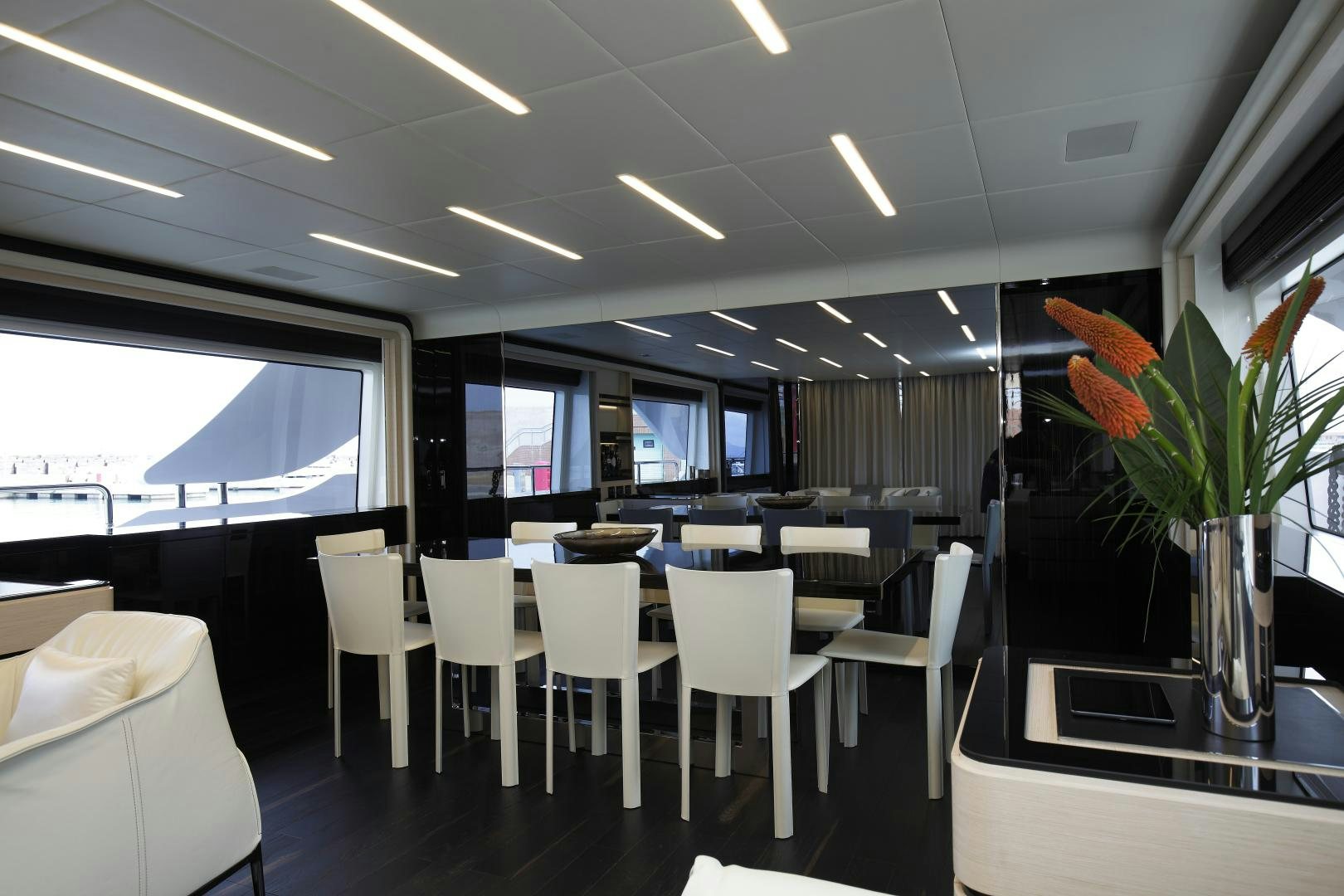 a room with tables and chairs aboard NOVASTAR Yacht for Sale