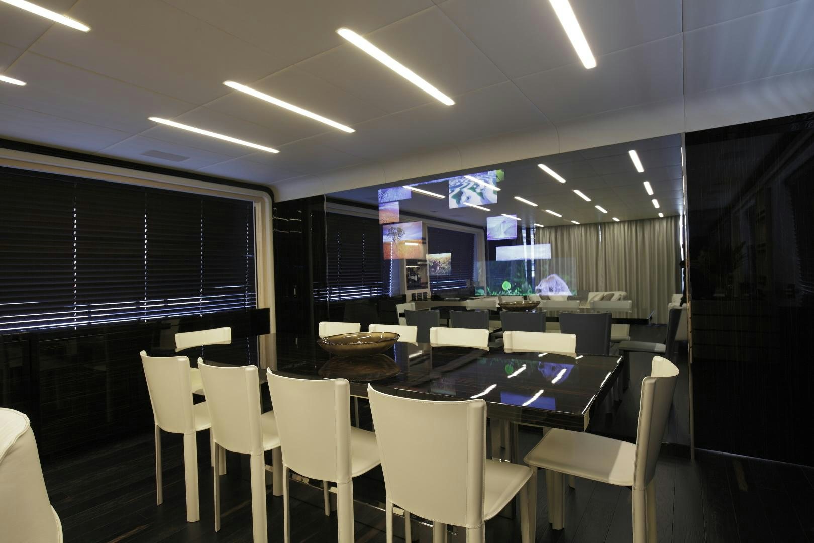 a room with tables and chairs aboard NOVASTAR Yacht for Sale