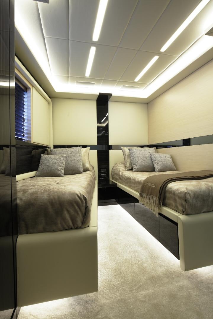 a room with a bed and a chair aboard NOVASTAR Yacht for Sale