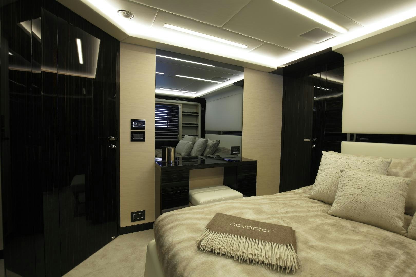a room with a bed and a desk aboard NOVASTAR Yacht for Sale
